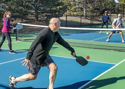 Two couples play tennis with each other, an example of how you might use free time.