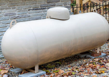 An image of a propane tank is featured, showcasing the importance of propane tank placement.