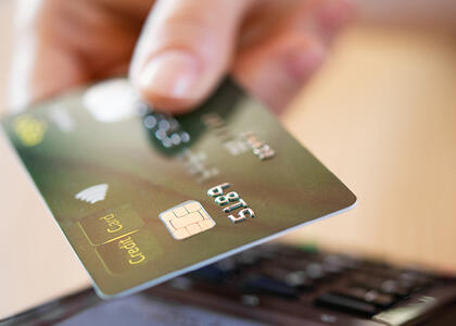 Payment processing strategy is represented by a photo of a customer using a card.