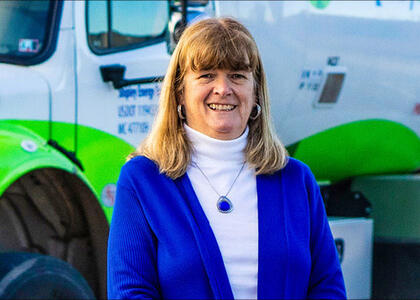 Beth Donovan smiling in front of a propane truck