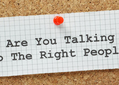A note pinned to a board saying, "Are You Talking To The Right People?"