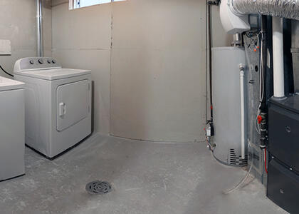 A picture shows a basement with a heating unit in place.