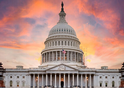 A picture of the capitol building and the sunset behind it, where Propane Days takes place.