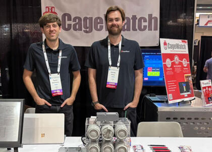The founders of CageWatch, a company boosting current forklift propane cage technology, pose at their booth at a propane event. 