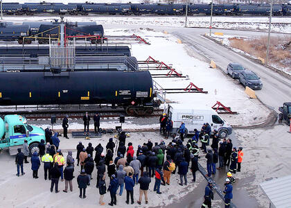 Attendees at the event look on as speeches commence at the terminal.