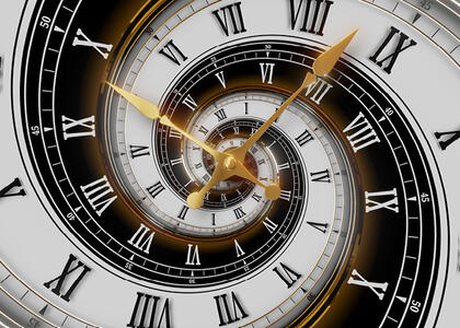 A clock is featured, showcasing the topic of time travel in this month's Verbatim