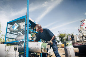 A photo of a propane provider restocking propane cylinders. Prefill inspection is important to do before that.