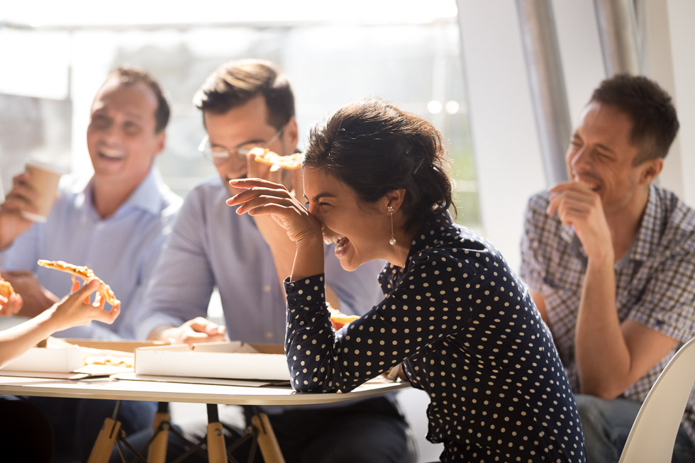 Office coworkers laugh at their funniest work memory.